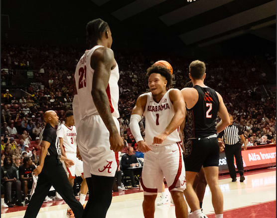 Alabama guard Mark Sears (1) flexes as he celebrates a dunk by Alabama forward Nick Pringle (23) against Mercer at Coleman Coliseum. Photo | Gary Cosby Jr.-USA TODAY Sports