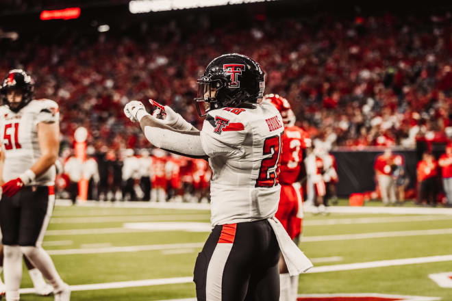 Tahj Brooks celebrates in the end zone after a touchdown run against Houston