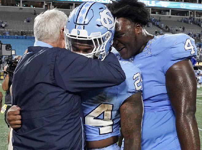 UNC Coach Mack Brown shares an emotional moment with running back British Brooks Saturday night in Charlotte.