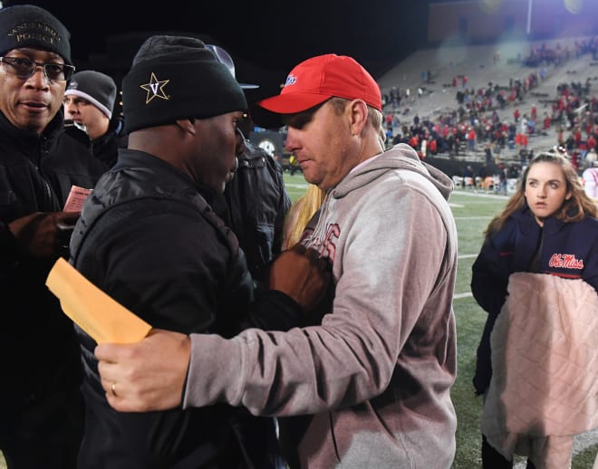 Vanderbilt coach Derek Mason and Ole Miss coach Hugh Freeze meet at midfield following the Commodores' win over the Rebels Saturday in Nashville.