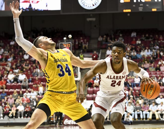 Alabama forward Brandon Miller (24) commits an offensive foul against South Dakota State guard Alex Arians (34) at Coleman Coliseum. Alabama won 78-65. Photo | Gary Cosby Jr.-USA TODAY Sports