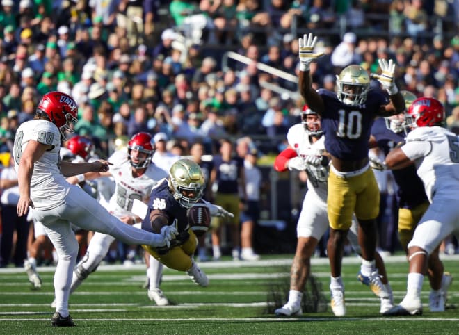 Notre Dame's Isaiah Foskey left and Prince Kollie (10) converge to block a punt against UNLV last Oct. 22.