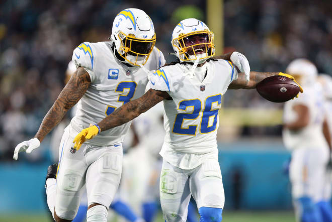 Asante Samuel Jr. (26) had three interceptions in the Chargers' loss on Saturday. Above, he celebrates an INT with Derwin James.
