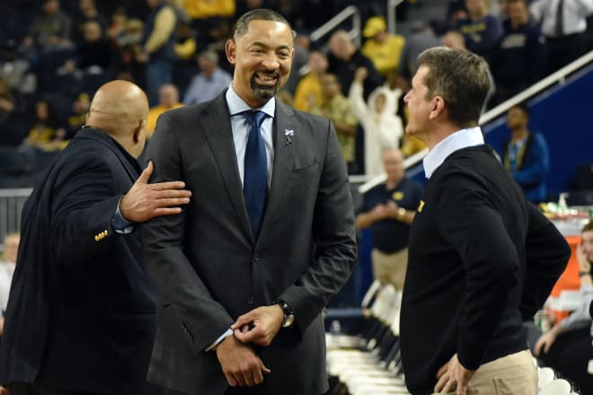 Michigan Wolverines' Juwan Howard and Jim Harbaugh