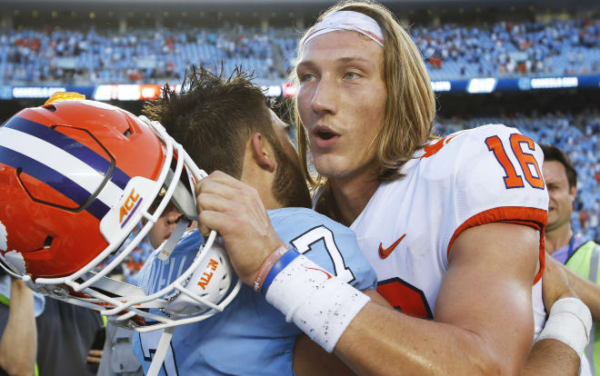 Clemson quarterback Trevor Lawrence embraces UNC QB Sam Howell in Kenan Stadium moments after the Tigers narrowly escaped with a 21-20 win.