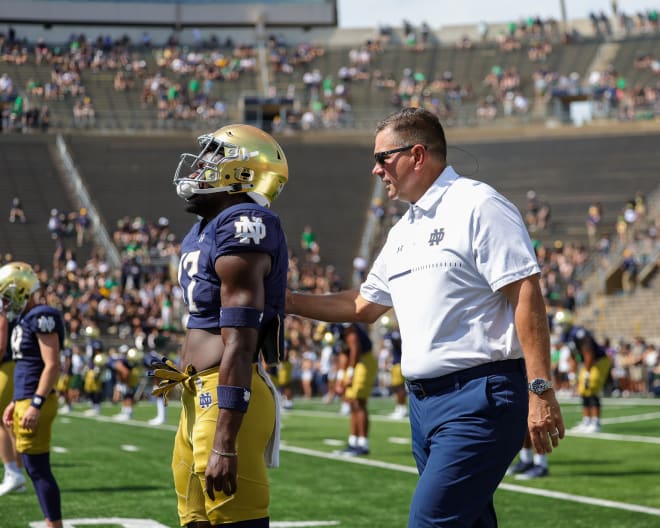 Notre Dame defensive coordinator Al Golden chats with freshman Jaylen Sneed (17) during warmups before last Saturday's loss to Marshall. 