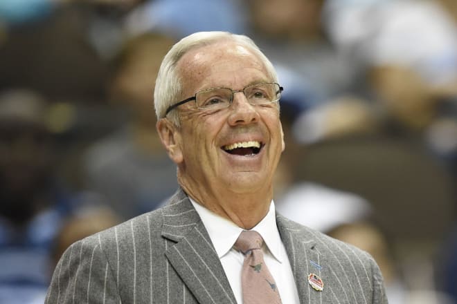 The legendary basketball coach and 10 other UNC coaches sign contract extensions with the university.