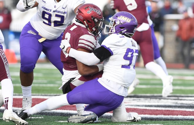James Madison defensive end John Daka (97) makes a tackle during the Dukes' second-round playoff loss at Colgate this past December.