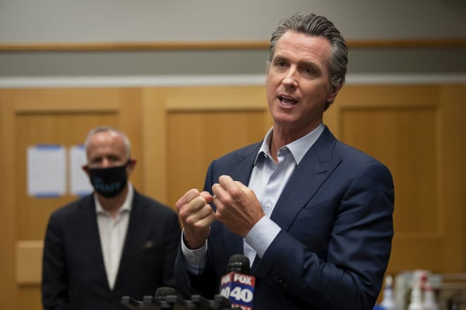 California Gov. Gavin Newsom, pictured in an earlier photo, was asked about the Pac-12's push to play Wednesday.
