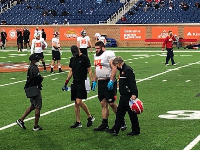 Ben Cleveland walks off the field after injuring his left ankle.