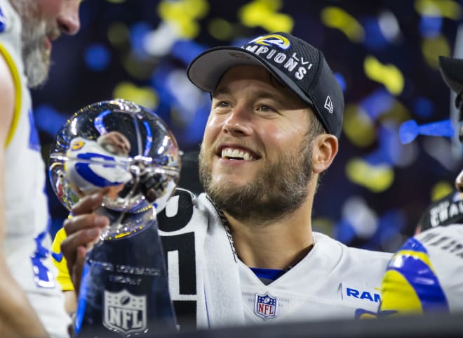 Georgia quarterback Matthew Stafford holds up his Detroit Lions