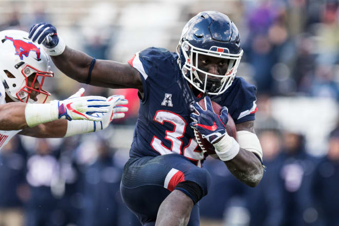 EAST HARTFORD, CT - NOVEMBER 10: UConn Huskies Running Back Kevin Mensah (34) evades a tackle on route to a 19 yard touchdown during the second half of a college football game between the SMU Mustangs and the UConn Huskies on November 10, 2018, at Pratt & Whitney Stadium at Rentschler Field in East Hartford, CT.
