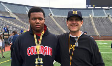Watkins poses for a picture with Michigan head coach Jim Harbaugh after a spring practice.