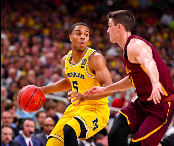 Jaaron Simmons' huge triple sparked Michigan to a win over Loyola.