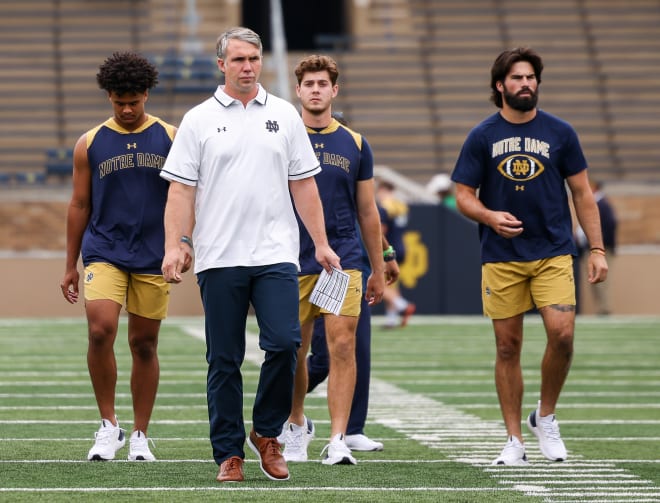 Notre Dame QBs coach Gino Guidugli looks to be coaching presumed returnees Kenny Minchey (left) and Steve Angeli (center) next season with another transfer who will replace Sam Hartman (right) on the Irish roster.