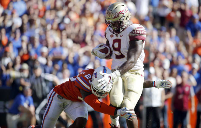 Nov 25, 2017; Gainesville, FL, USA; Florida State Seminoles running back Jacques Patrick (9) runs with the ball as Florida Gators defensive back Chauncey Gardner Jr. (23) tackles during the second quarter at Ben Hill Griffin Stadium. 