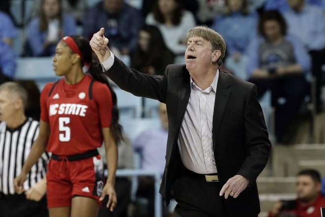 NC State women's basketball coach Wes Moore points on the sideline.