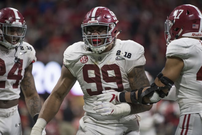 Raekwon Davis No. 99 of the Alabama Crimson Tide celebrates a stop on defense against the Georgia Bulldogs during the College Football Playoff National Championship held at Mercedes-Benz Stadium on January 8, 2018 in Atlanta, Georgia. Alabama defeated Georgia 26-23 for the national title. Photo | Getty Images 