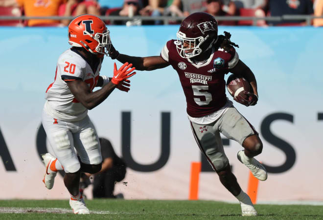 Jan 2, 2023; Tampa, FL, USA; Mississippi State Bulldogs wide receiver Lideatrick Griffin (5) stiff arms Illinois Fighting Illini defensive back Tyler Strain (20) during the second half in the 2023 ReliaQuest Bowl at Raymond James Stadium.
