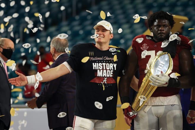 Alabama quarterback Mac Jones (left) and offensive lineman Alex Leatherwood (right) celebrate following the Tide's national championship win over Ohio State. Photo | Getty Images