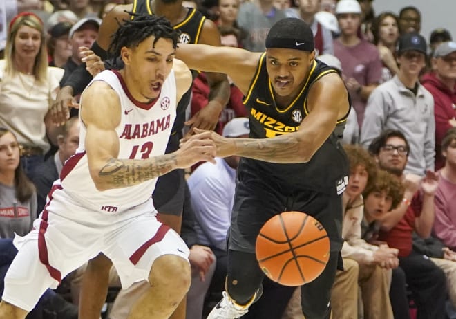 Alabama Crimson Tide guard Jahvon Quinerly (13) goes for a lose ball against Missouri Tigers guard Jarron Coleman (5) during the second half at Coleman Coliseum. Photo | Marvin Gentry-USA TODAY Sports