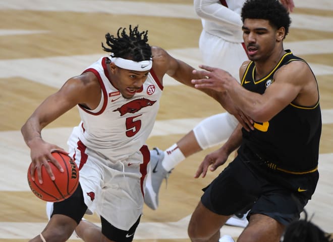 Moses Moody drives past Mark Smith in second round of SEC tournament.