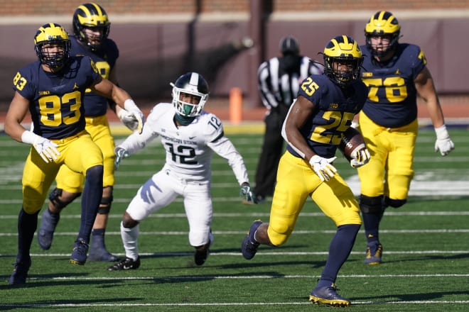 Michigan Wolverines football running back Hassan Haskins ripped off a 19-yard run against the Michigan State Spartans.