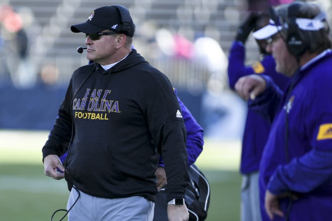 East Carolina coach Mike Houston walks the sideline during the Pirates' 31-24 win over Connecitcut in November at Rentschler Field in East Hartford, Conn.