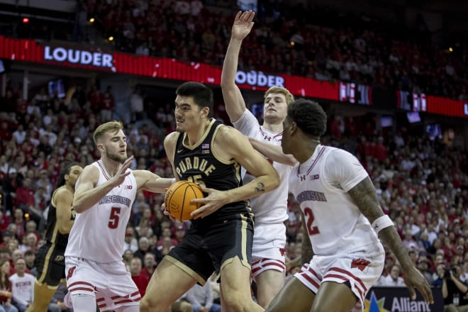 Tyler Wahl (5), Steven Crowl (back), and A.J. Storr (2) collapse on Purdue center Zach Edey