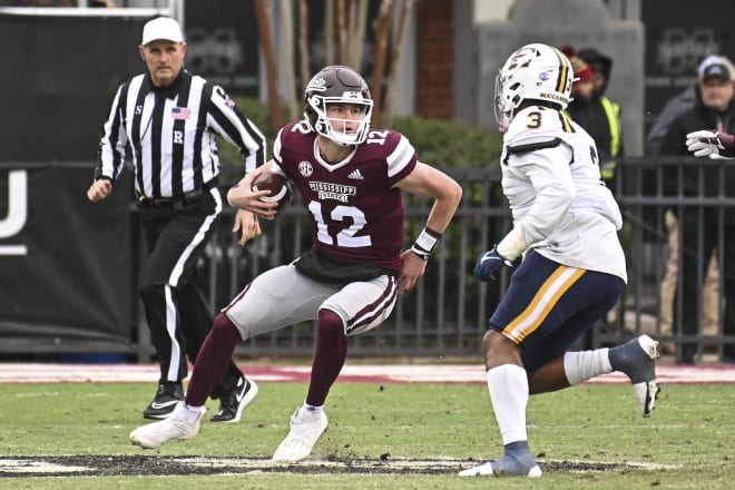 Nov 19, 2022; Starkville, Mississippi, USA; Mississippi State Bulldogs quarterback Sawyer Robertson (12) runs the ball while defended by East Tennessee State Buccaneers linebacker Jalen Porter (3) during the fourth quarter at Davis Wade Stadium at Scott Field.