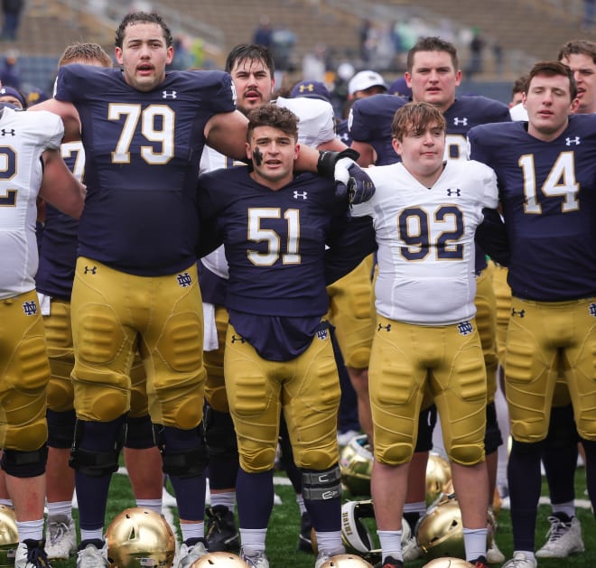 Notre Dame 6-foot-8 left tackle Tosh Baker (79), 5-7 Rino Monteforte and the rest of the Irish sing the Alma Mater after last spring's Blue=Gold Game.