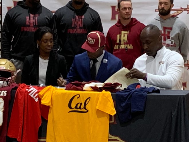 Raymond Woodie III signs with Florida State at a ceremony at Florida High School on Wednesday. 