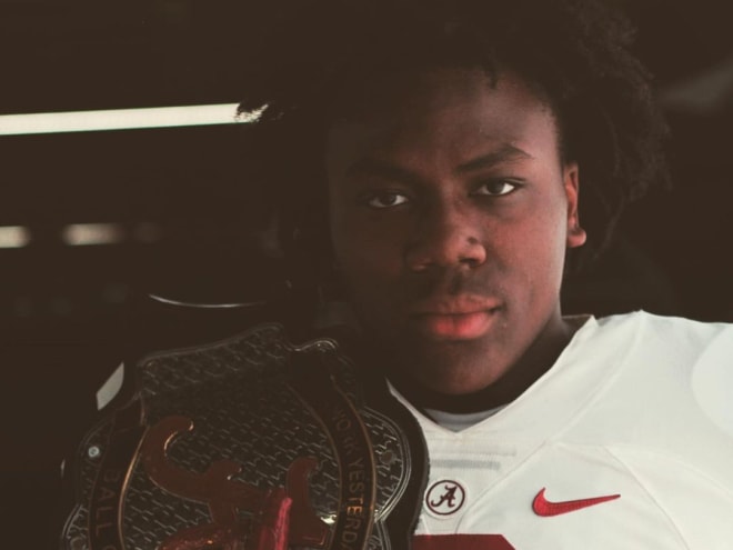 Hill posing in an Alabama uniform during a visit this summer