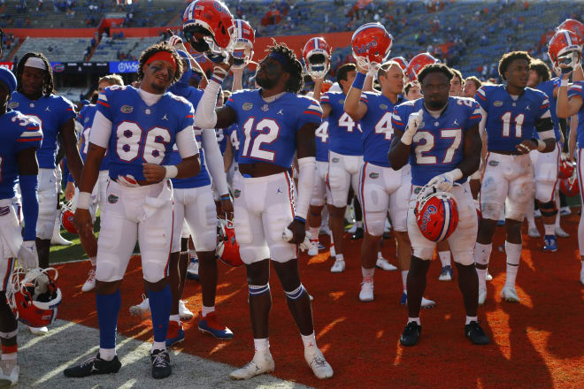 Nov 13, 2021; Gainesville, Florida, USA; Florida Gators wide receiver Rick Wells (12), wide receiver Jordan Pouncey (86), running back Dameon Pierce (27) and teammates celebrate after beating the Samford Bulldogs at Ben Hill Griffin Stadium. Credit: Kim Klement-USA TODAY Sports