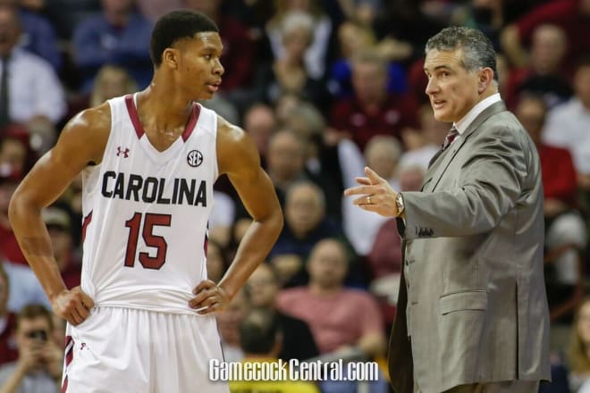 Frank Martin gives instructions to P.J. Dozier