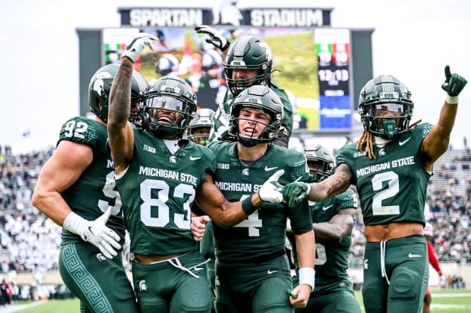 Michigan State's Montorie Foster Jr., left, celebrates his touchdown catch with teammates during the fourth quarter in the game against Nebraska on Saturday, Nov. 4, 2023, at Spartan Stadium in East Lansing. © Nick King/Lansing State Journal/USA TODAY NETWORK