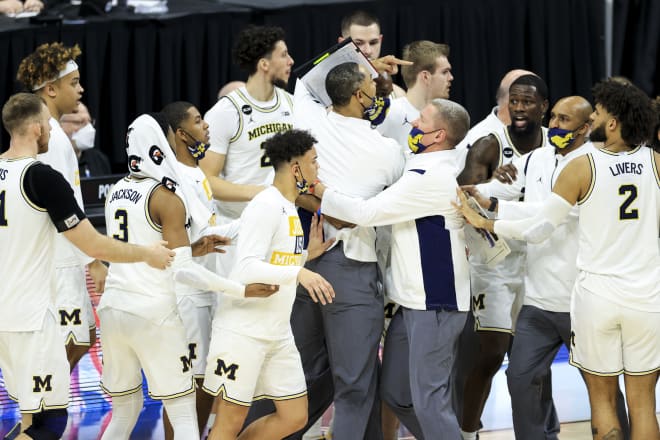 U-M staffer Jay Smith heads of head coach Juwan Howard when things got testy in the second half.