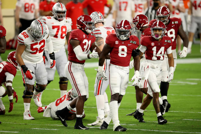 Alabama defenders Will Anderson Jr. (31), Christian Harris (8) and Brian Branch (14) celebrate a play against Ohio State in the national championship game. Photo | Getty Images 