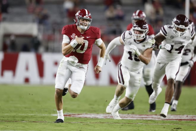 Alabama Crimson quarterback Mac Jones runs the ball against Mississippi State. Photo | SEC