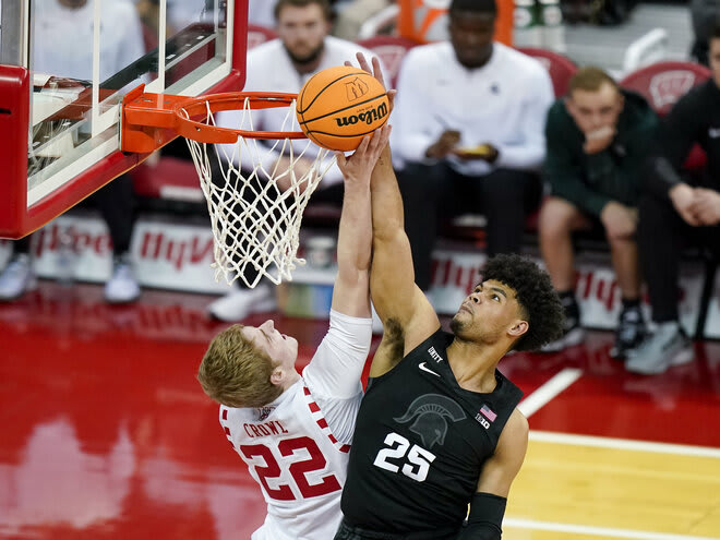 Michigan State's Malik Hall (25) blocks a shot by Wisconsin's Steven Crowl (22). The Badgers were outscored 32-24 in the paint.