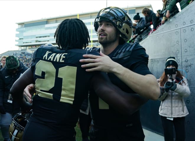 Nov 25, 2023; West Lafayette, Indiana, USA; Purdue Boilermakers defensive back Sanoussi Kane (21) and Purdue Boilermakers quarterback Hudson Card (1) celebrate after the game at Ross-Ade Stadium. Mandatory Credit: Robert Goddin-USA TODAY Sports