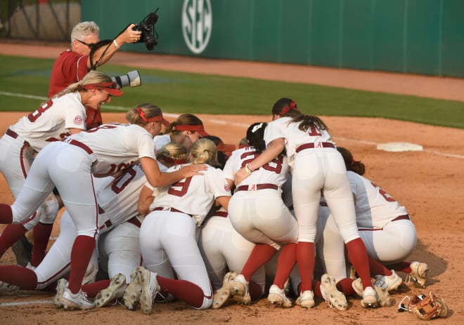 Alabama player pile in around Alabama pitcher Montana Fouts (14) after the final out Sunday, May 28, 2023, at Rhoads Stadium in Tuscaloosa. Alabama advanced to the College World Series with a 3-2 win. Photo | Gary Cosby Jr.-Tuscaloosa News / USA TODAY NETWORK