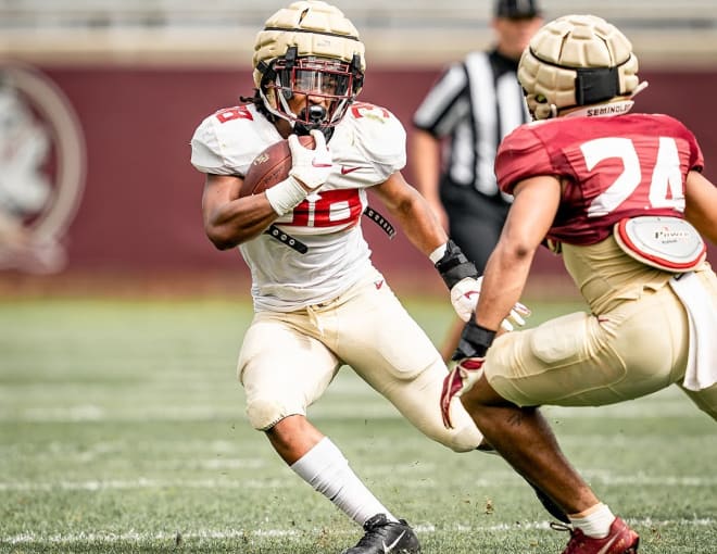 FSU tailback Treshaun Ward looks to avoid the tackle of defensive back Jadarius Green-McKnight in the second spring scrimmage.