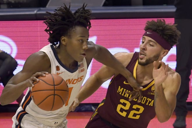 Illinois star Ayo Dosunmu drives with Gopher guard Gabe Kalscheur on him