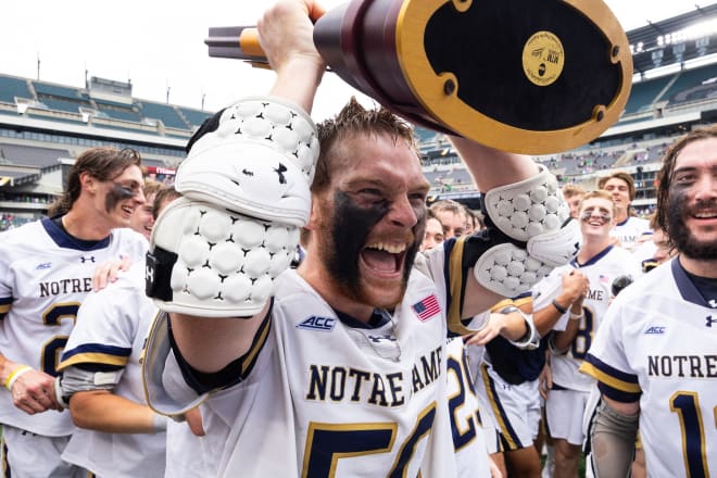 Notre Dame's Chris Kavanagh celebrates with the championship trophy after scoring five goals Monday in a 15-5 Irish win over Maryland to tin the NCAA title.
