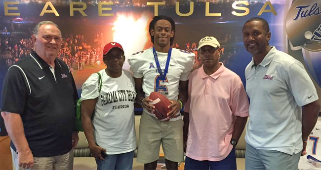 Manny Bunch (center) with his family and TU coaches Bill Young (left) and Brian Norwood (right)