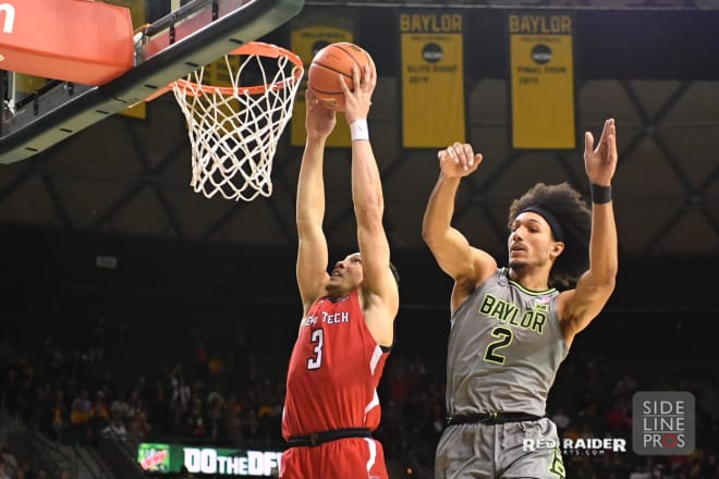 Clarence Nadolny (3) scores two of his 11 points on Baylor defender Kendall Brown (2)