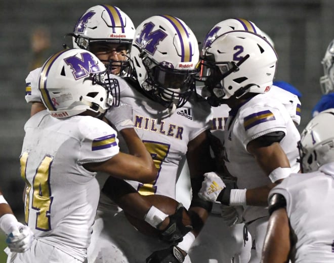 Miller's Lonnie Adkism, center, is surrounded by teammates after incepting the ball at the playoff game against Lampasas, Saturday, Nov. 21, 2020, at Dub Farris Stadium in San Antonio. Miller won, 54-49.