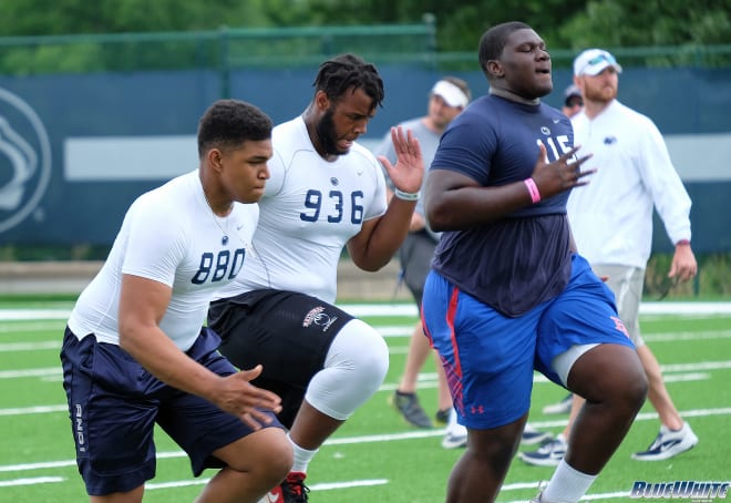 Achumba (right) warms up with future Florida OL Will Harrod (middle) and Stanford OL Walter Rouse (left) at Penn State's Whiteout Camp last June.