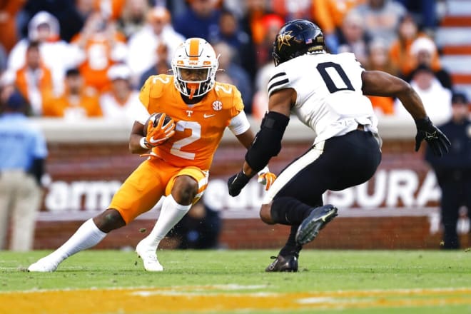 Tennessee running back Jabari Small (2) runs for yardage as he's pressured by Vanderbilt linebacker Anfernee Orji (0) during the first half of an NCAA college football game Saturday, Nov. 27, 2021, in Knoxville, Tenn. (AP Photo/Wade Payne)